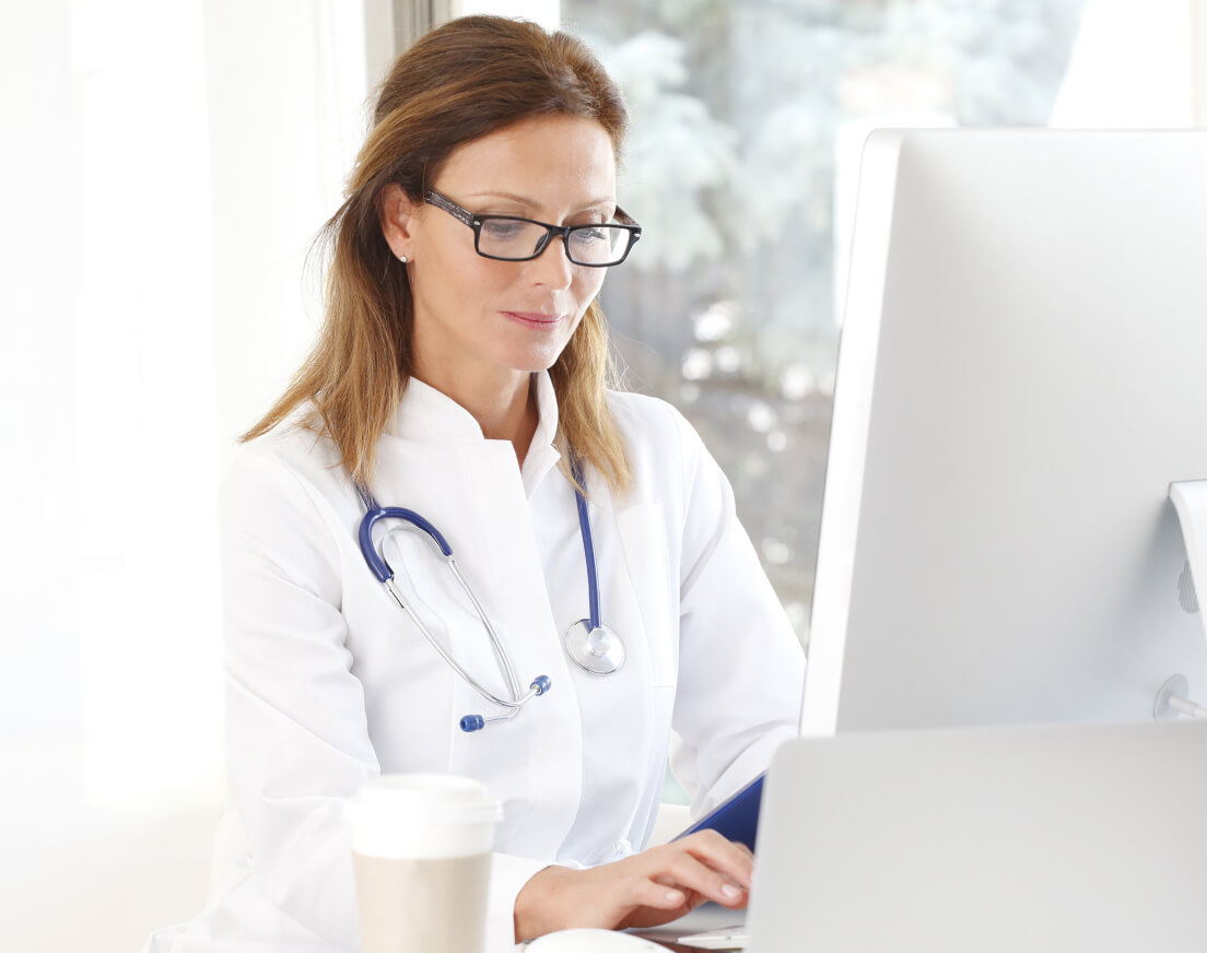 Female doctor working at a computer