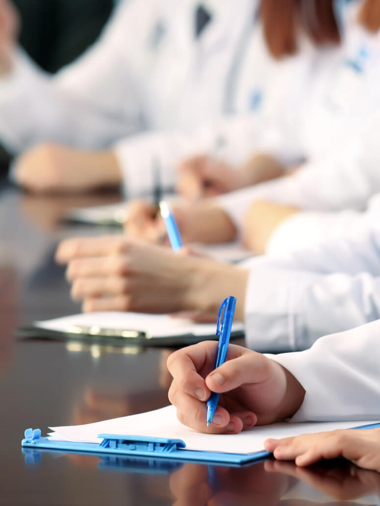 Doctors writing on clipboards