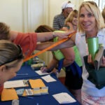 A woman having her arm measured for golfing