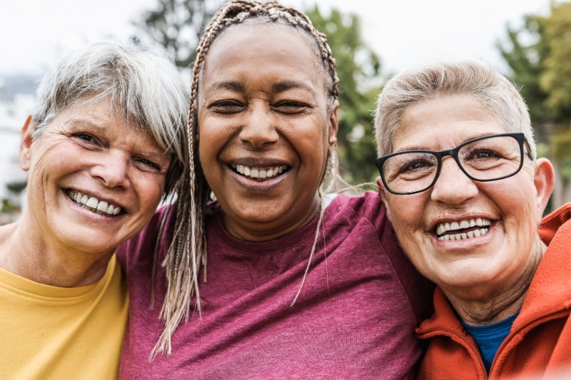 Women embracing and smiling